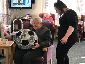 students talking to older people in care home